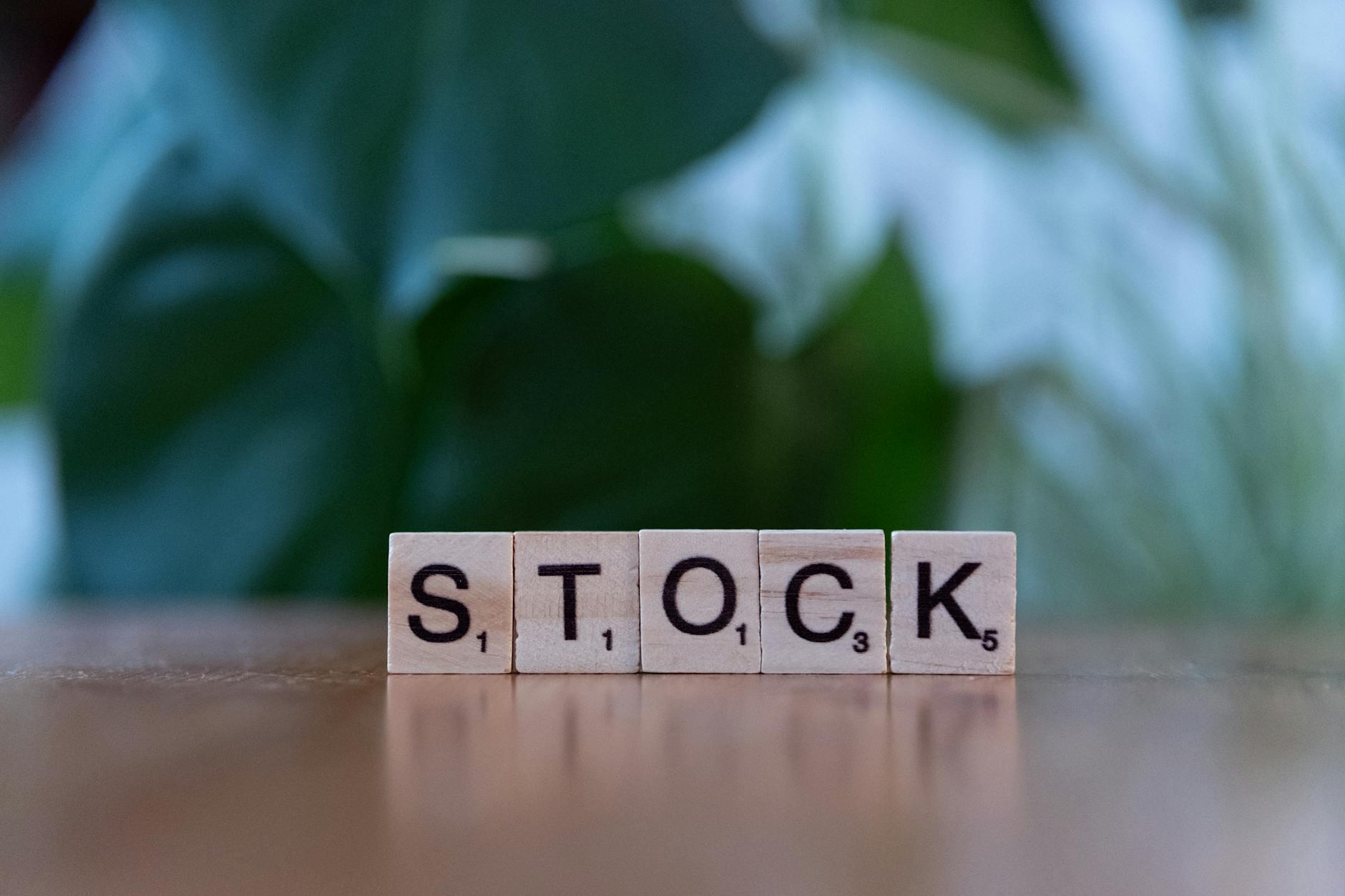 wooden letter blocks spelling stock on table