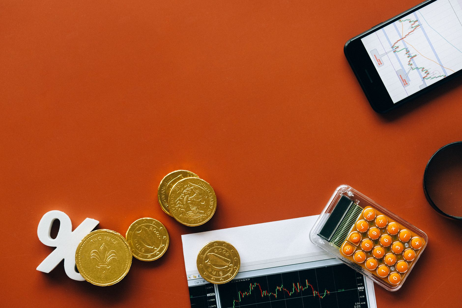 coins and financial graphs on red background